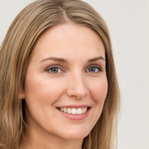 Joyful white young-adult female with long  brown hair and green eyes