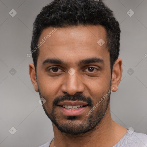 Joyful latino young-adult male with short  black hair and brown eyes