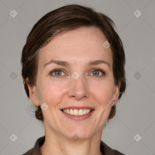 Joyful white adult female with medium  brown hair and grey eyes