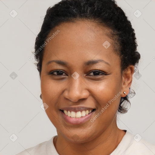 Joyful black young-adult female with short  brown hair and brown eyes