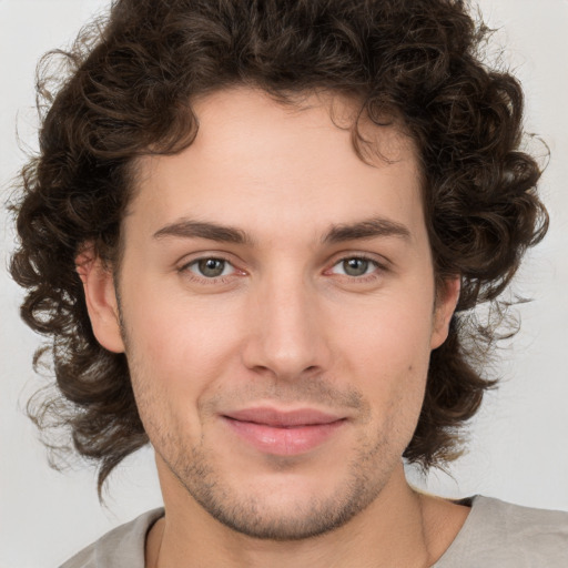 Joyful white young-adult male with medium  brown hair and brown eyes