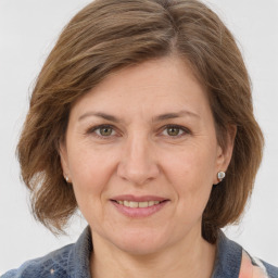 Joyful white adult female with medium  brown hair and grey eyes