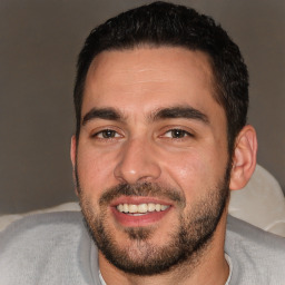 Joyful white young-adult male with short  black hair and brown eyes