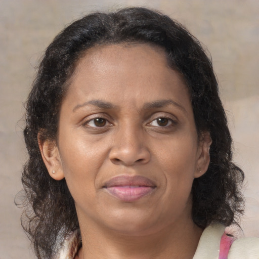 Joyful black adult female with medium  brown hair and brown eyes