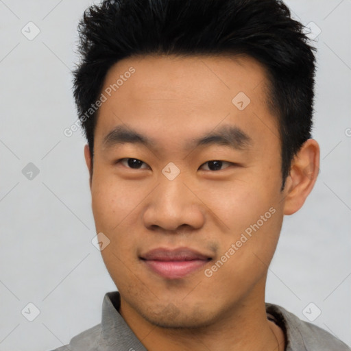 Joyful asian young-adult male with short  black hair and brown eyes