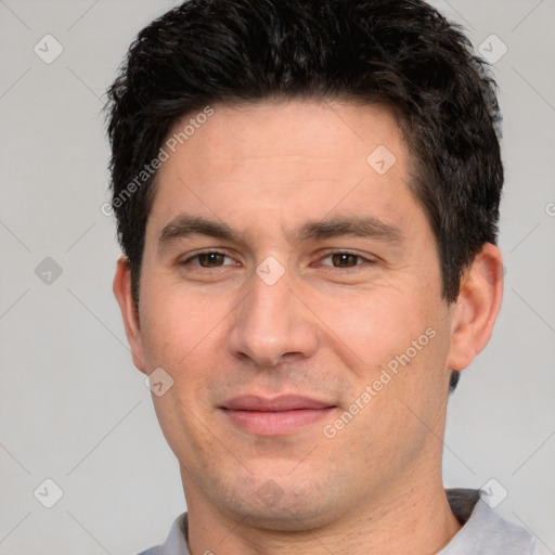 Joyful white adult male with short  black hair and brown eyes