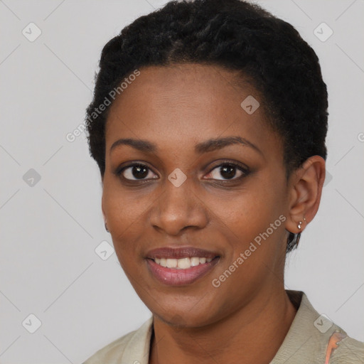 Joyful black young-adult female with short  black hair and brown eyes