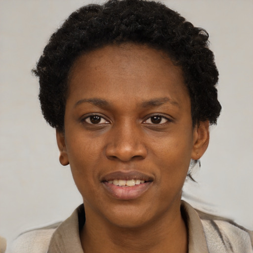 Joyful black young-adult female with short  black hair and brown eyes