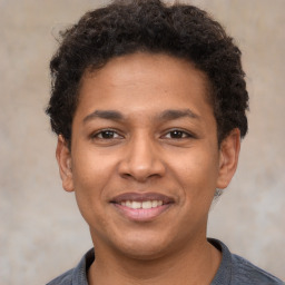 Joyful latino young-adult male with short  brown hair and brown eyes