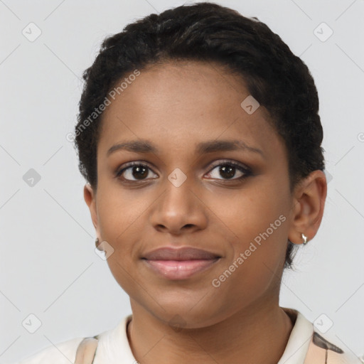 Joyful black young-adult female with short  brown hair and brown eyes