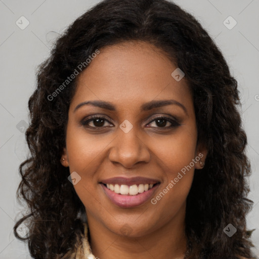 Joyful black young-adult female with long  brown hair and brown eyes