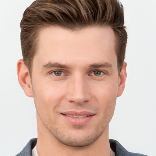 Joyful white young-adult male with short  brown hair and grey eyes