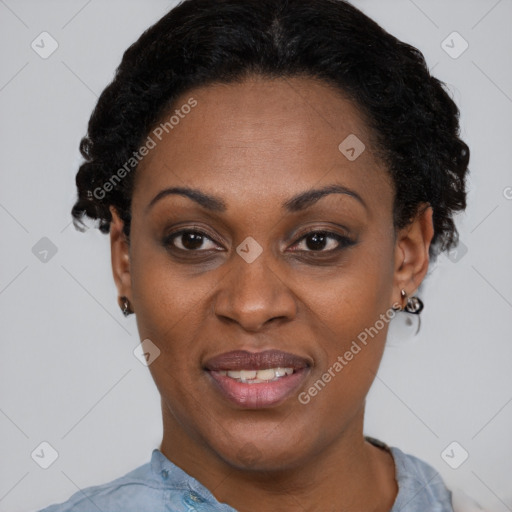 Joyful black adult female with short  black hair and brown eyes