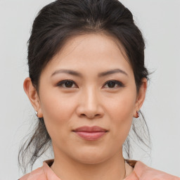 Joyful asian young-adult female with medium  brown hair and brown eyes