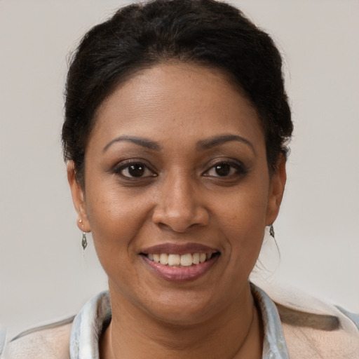 Joyful black adult female with short  brown hair and brown eyes