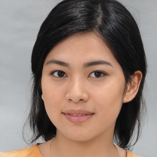 Joyful asian young-adult female with medium  black hair and brown eyes