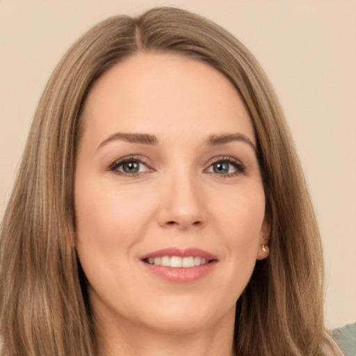 Joyful white young-adult female with long  brown hair and brown eyes