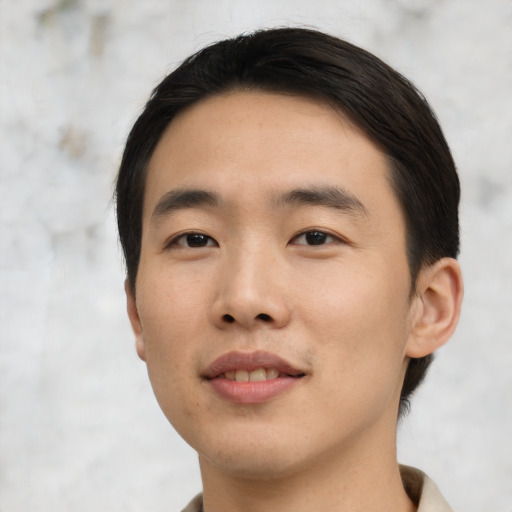 Joyful asian young-adult male with short  black hair and brown eyes