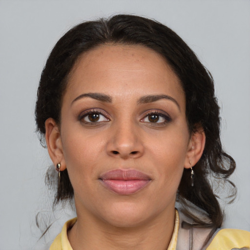 Joyful latino young-adult female with medium  brown hair and brown eyes