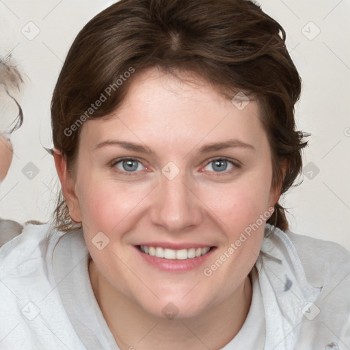 Joyful white young-adult female with medium  brown hair and blue eyes