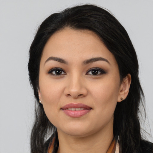 Joyful latino young-adult female with long  black hair and brown eyes