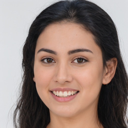 Joyful white young-adult female with long  brown hair and brown eyes