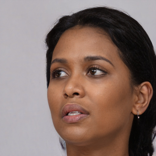 Neutral black young-adult female with long  black hair and brown eyes
