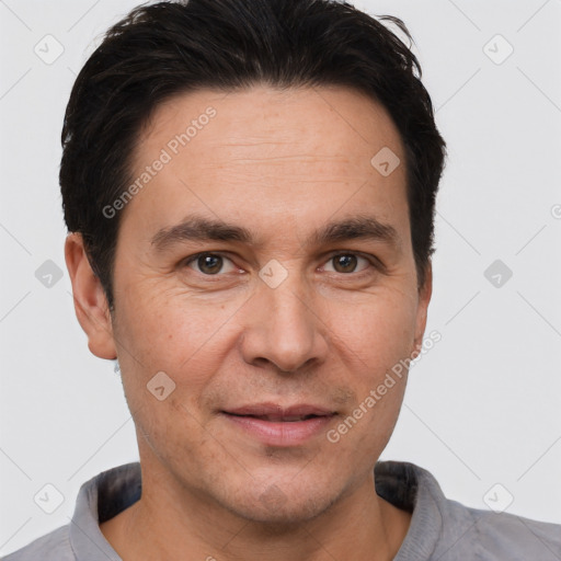 Joyful white adult male with short  brown hair and brown eyes