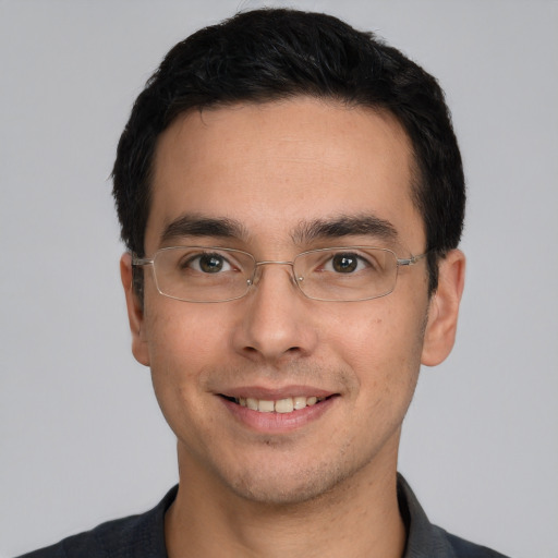 Joyful white young-adult male with short  black hair and brown eyes