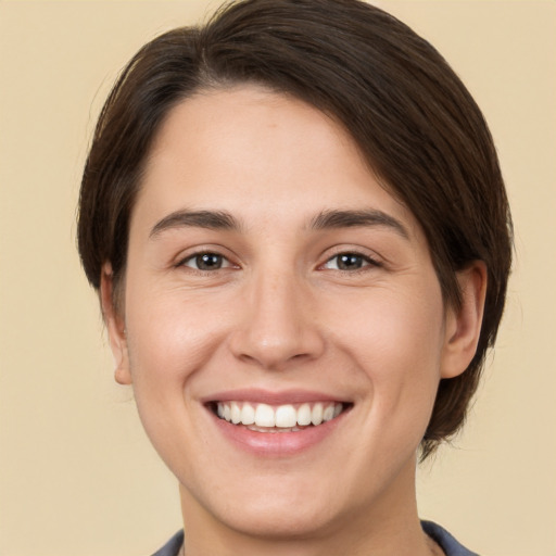 Joyful white young-adult female with medium  brown hair and brown eyes