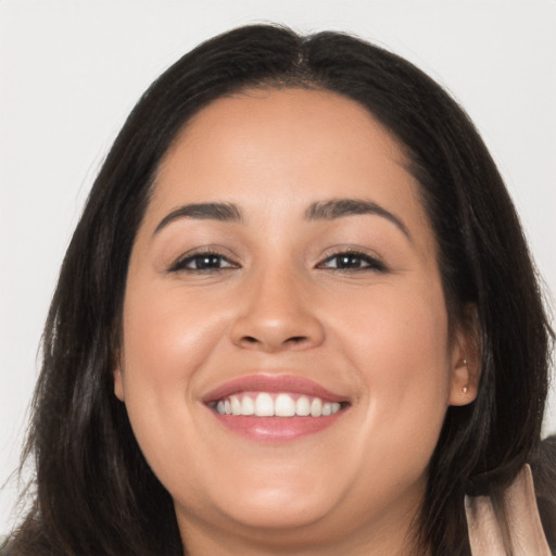 Joyful latino young-adult female with long  brown hair and brown eyes