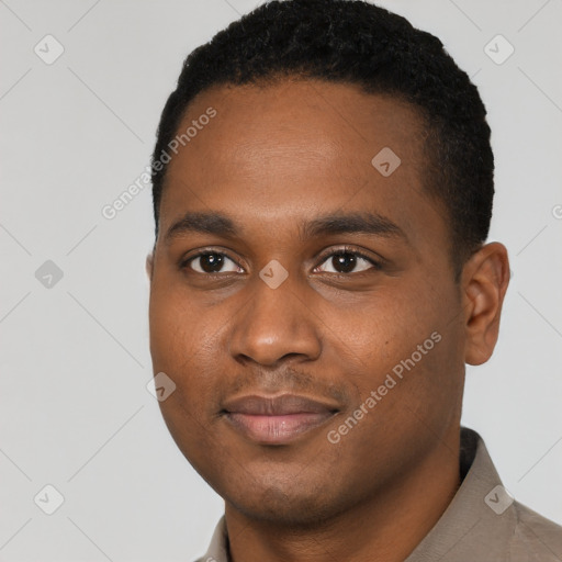 Joyful black young-adult male with short  black hair and brown eyes