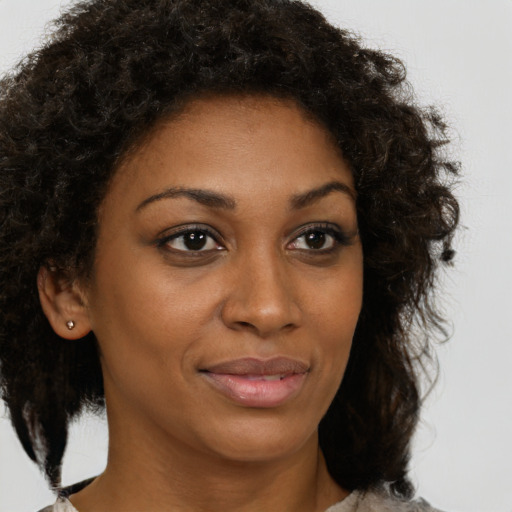 Joyful black young-adult female with medium  brown hair and brown eyes