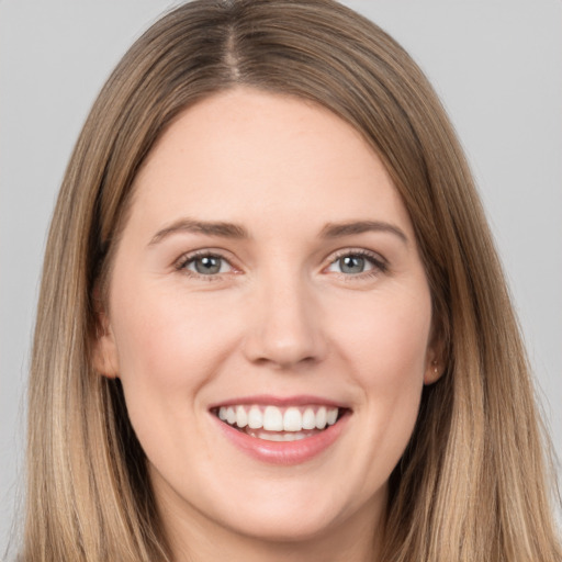 Joyful white young-adult female with long  brown hair and brown eyes