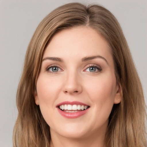 Joyful white young-adult female with long  brown hair and grey eyes