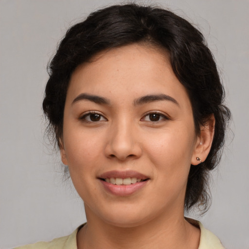 Joyful latino young-adult female with medium  brown hair and brown eyes