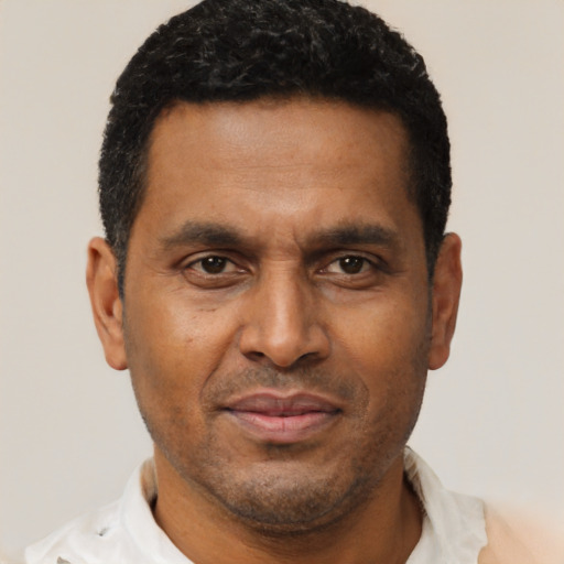 Joyful latino adult male with short  brown hair and brown eyes