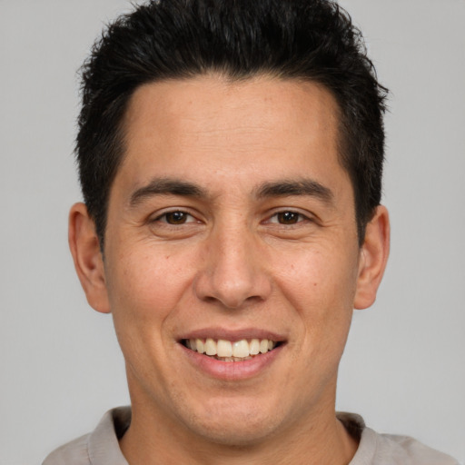 Joyful white adult male with short  brown hair and brown eyes