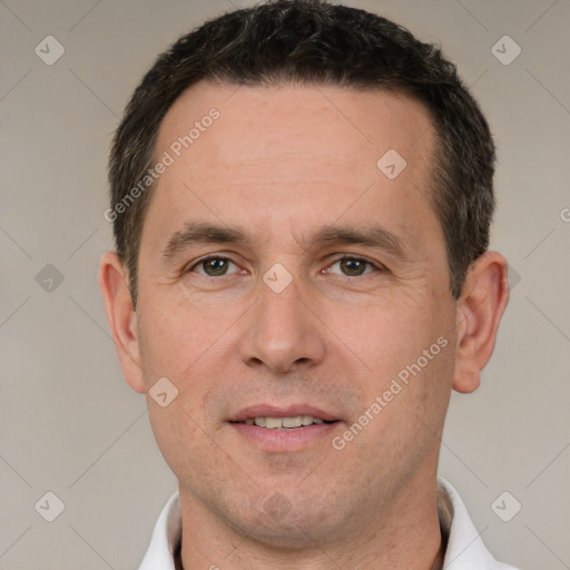 Joyful white adult male with short  brown hair and brown eyes