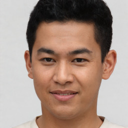 Joyful asian young-adult male with short  black hair and brown eyes