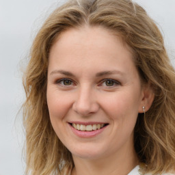 Joyful white young-adult female with medium  brown hair and blue eyes