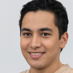 Joyful latino young-adult male with short  brown hair and brown eyes