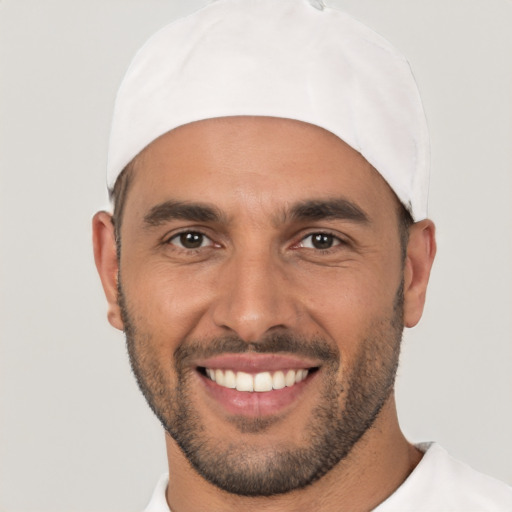 Joyful white young-adult male with short  black hair and brown eyes