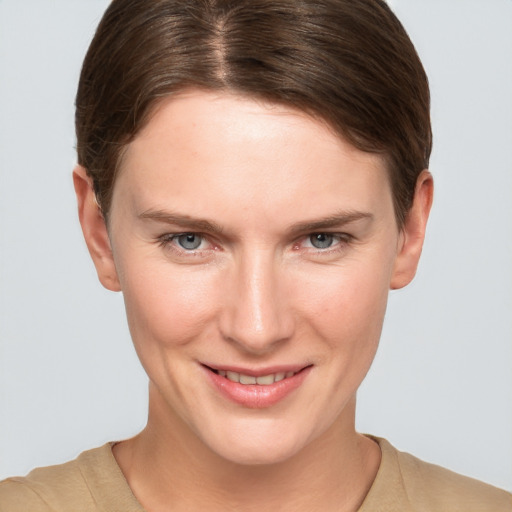 Joyful white young-adult female with short  brown hair and grey eyes