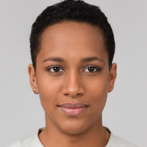 Joyful black young-adult female with short  black hair and brown eyes
