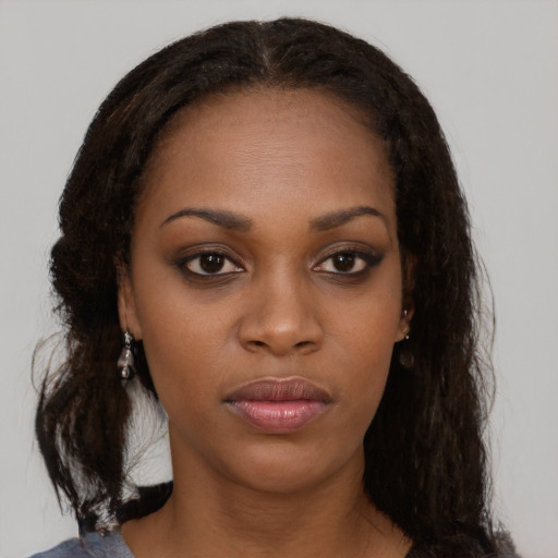 Neutral black young-adult female with medium  brown hair and brown eyes