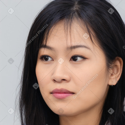 Joyful asian young-adult female with long  brown hair and brown eyes