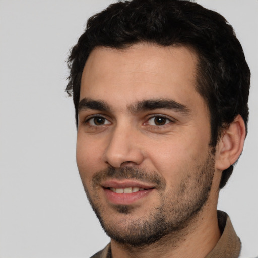 Joyful white young-adult male with short  black hair and brown eyes