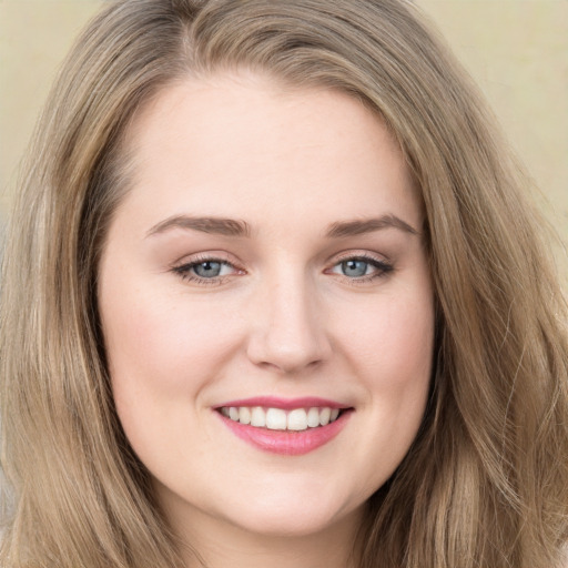 Joyful white young-adult female with long  brown hair and green eyes