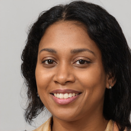 Joyful latino adult female with medium  brown hair and brown eyes